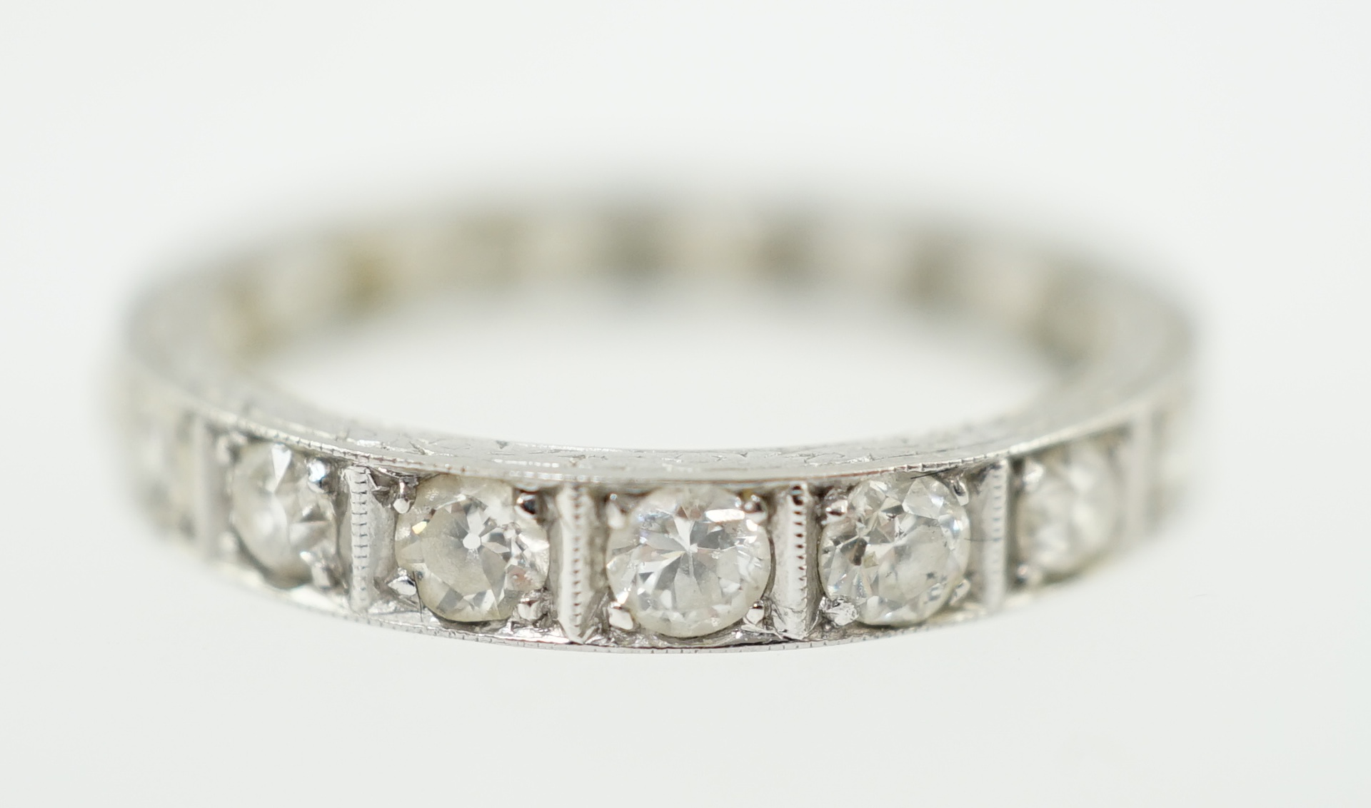 A mid 20th century platinum and diamond set full eternity ring